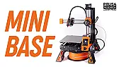 Printed four-legged stand lifts the MINI+ and hides spool and power brick |  When everything is assembled and powered up, the modified MINI+ sits raised on...